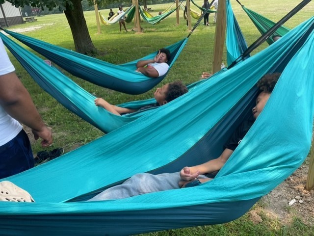 students sleeping in hammocks